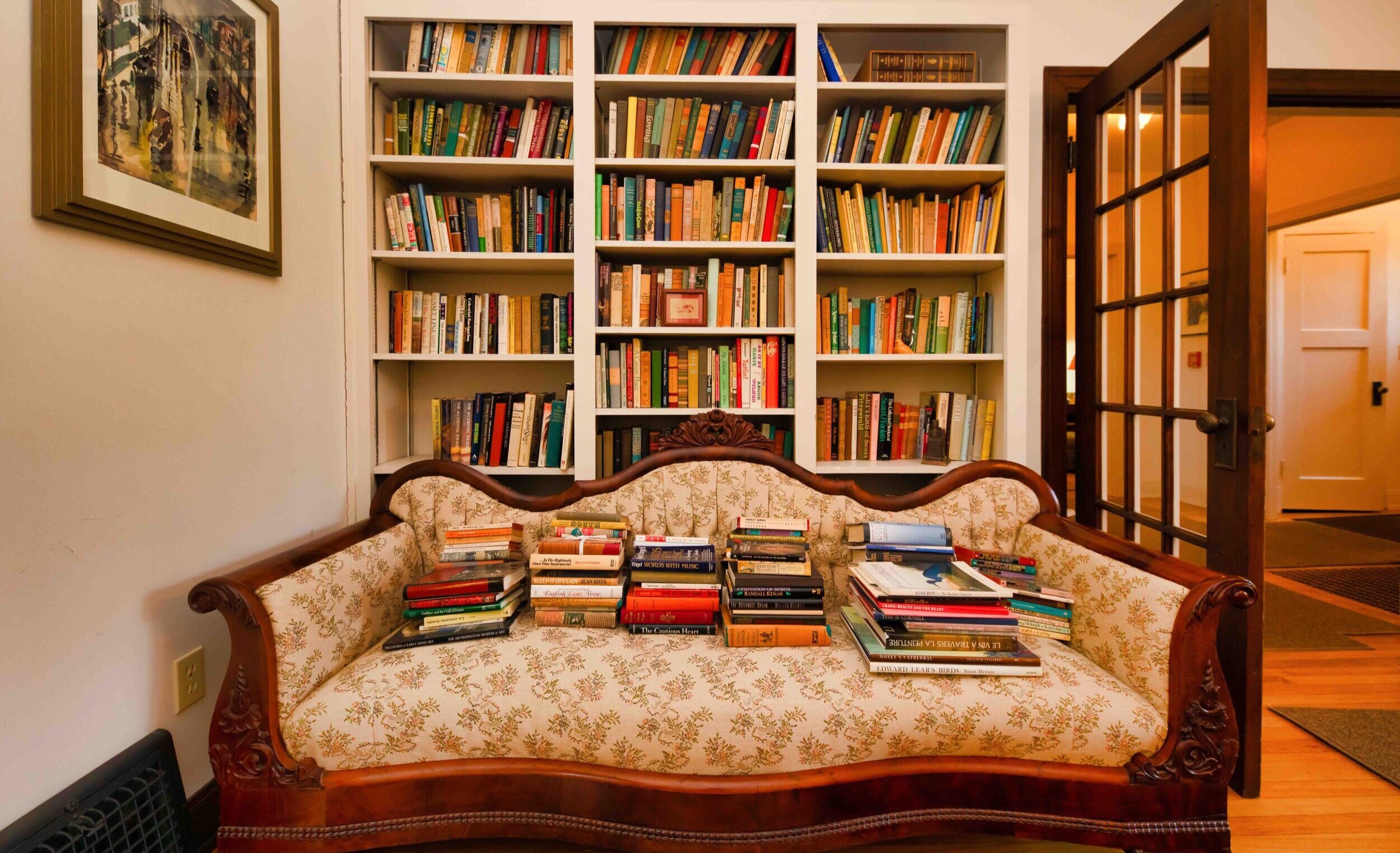 Every room in Welty's house features piles of books. Michael Pickard, professor of English at Millsaps, points out, "Surrounded by books, she lived without a washing machine, a dishwasher, a microwave, or central air conditioning." Photo by Tom Beck courtesy of MDAH